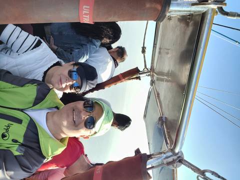 Two people taking a selfie in a hot air balloon basket.
