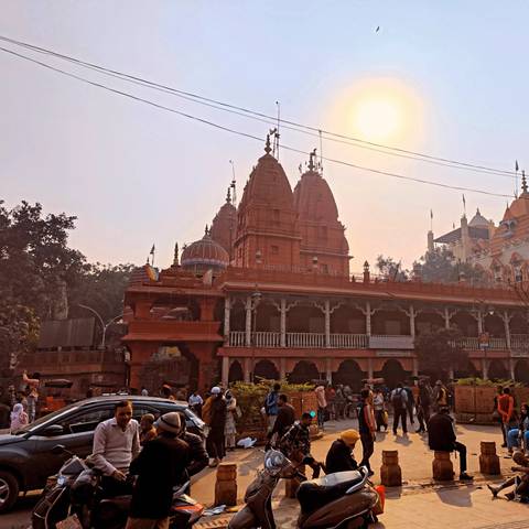 Historic temple with intricate architecture and sunlight streaming through the haze.
