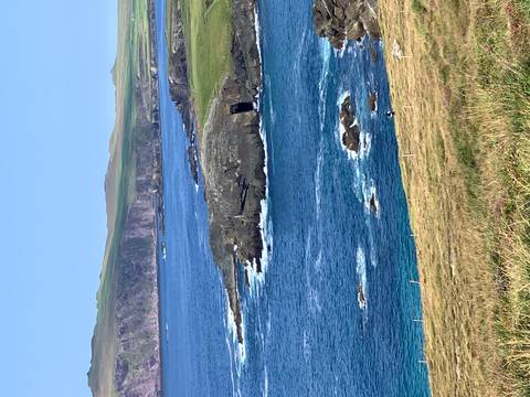       Beautiful coastline with rocky cliffs and blue ocean.
  