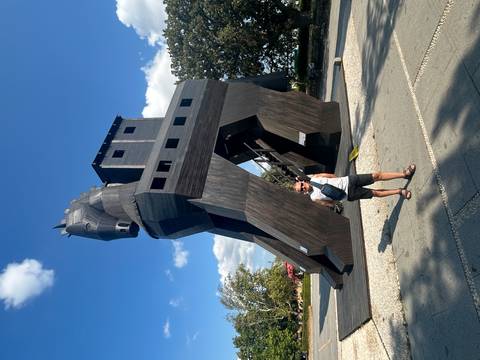       Man standing in front of the Trojan horse replica.
  