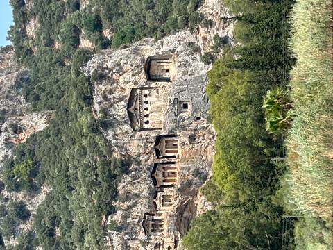       Rock tombs carved into a cliffside.
  