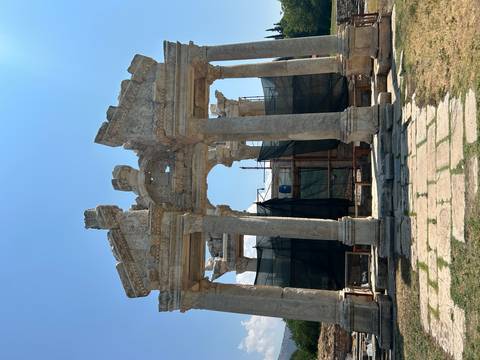       Ancient ruins with columns under restoration.
  