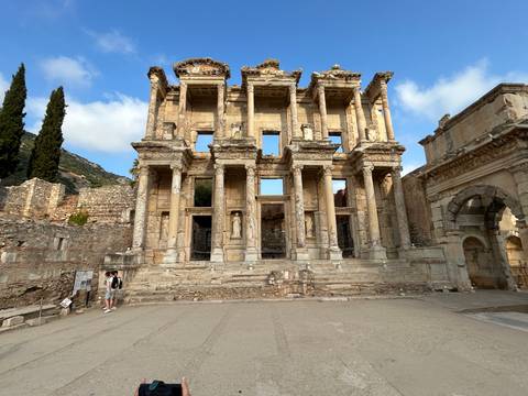       Facade of the Library of Celsus in Ephesus with tourists.
  