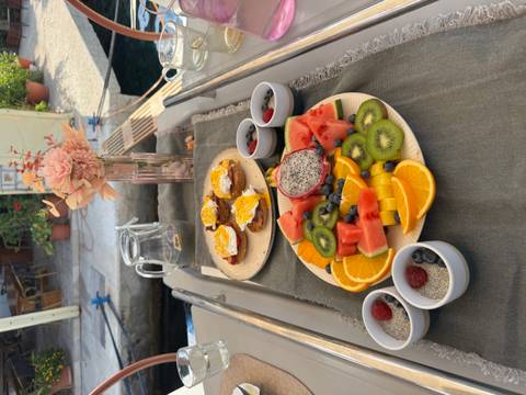 Beautifully arranged breakfast spread with fruits and pastries.