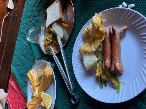 Assorted food items on a table including sausages and vegetables.