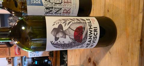       Close-up of a wine bottle with a label that reads 'Meanwhile in Viscri'.
  