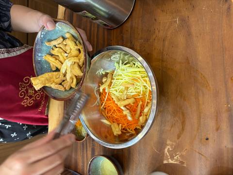       Close-up of ingredients being mixed in a kitchen.
  