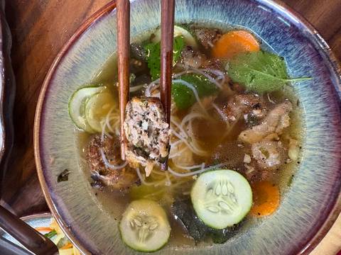       Detailed view of a noodle soup with chopsticks.
  