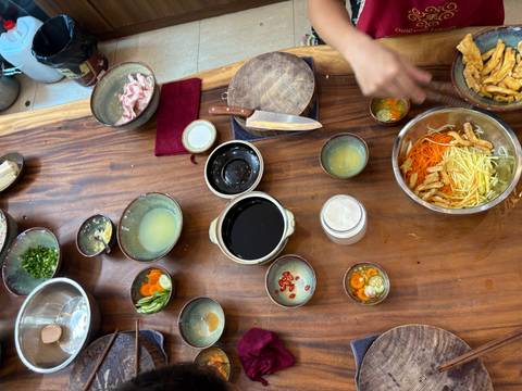       Assorted Vietnamese dishes with ingredients on a table.
  
