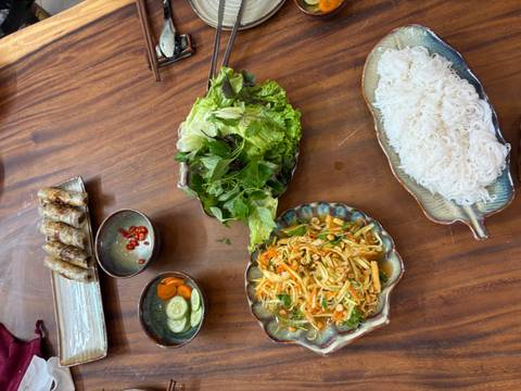       Arrangement of fresh vegetables and noodles on a decorative platter.
  