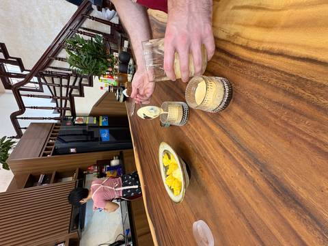       A kitchen with pineapple slices and drinks being prepared.
  