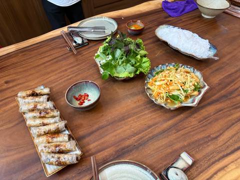       Prepared Vietnamese dishes on a wooden table.
  