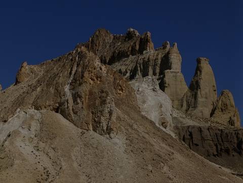       Jagged rock formations under a bright sky.
  