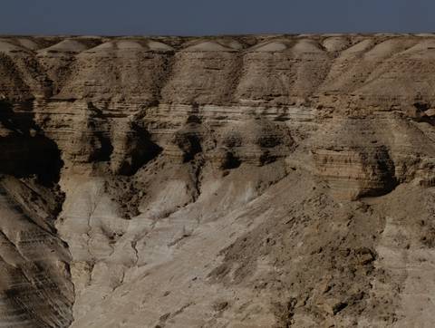       Eroded canyons with rough textures.
  