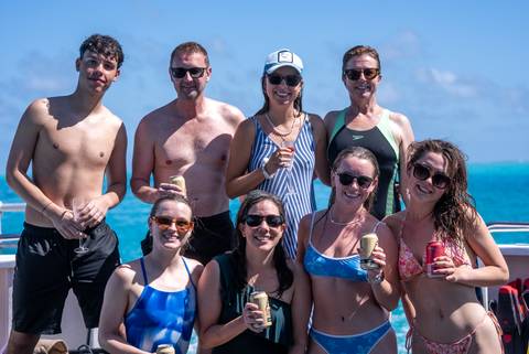 A group of people posing on a boat.