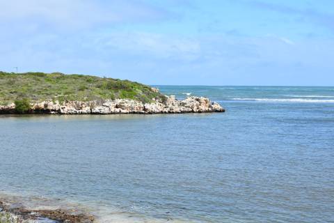 Coastal view with rocky shores and open sea.