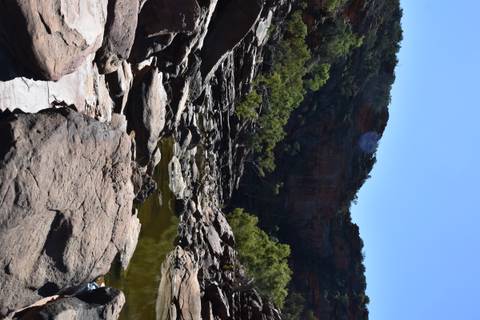 Rocky gorge with reflective water pools.