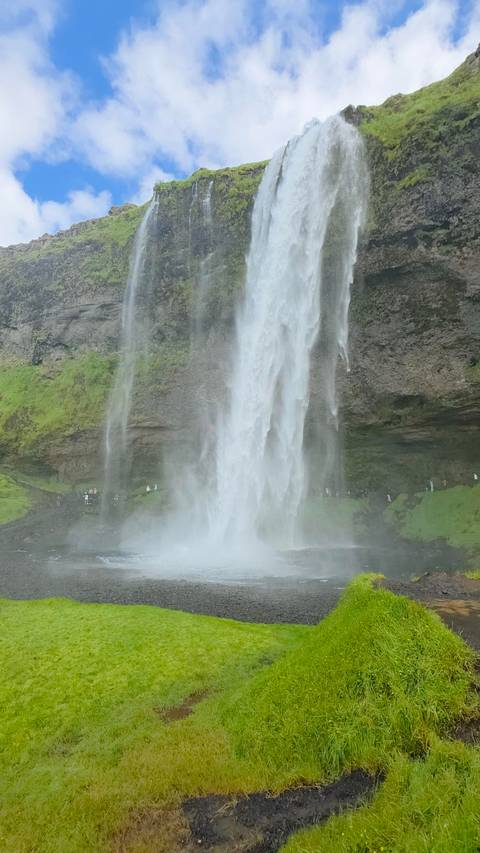       A waterfall flowing down a mountain.
  