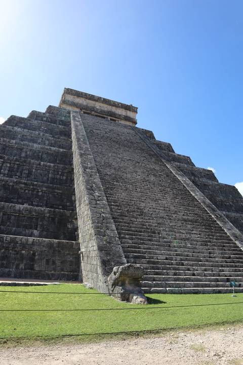 A Mayan pyramid with steep steps against the sky.