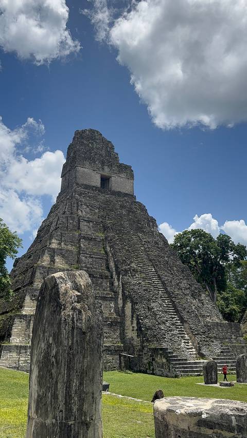 Ancient stone pyramid stairway under a blue sky.