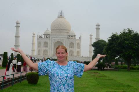 Person posing in front of the Taj Mahal.