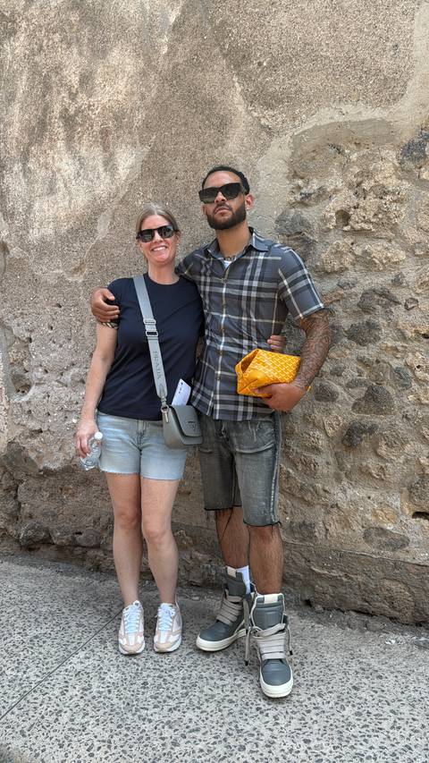 Two people embracing in casual attire.