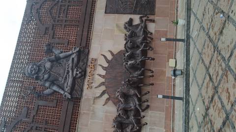 Large wall sculpture depicting a god and horses.