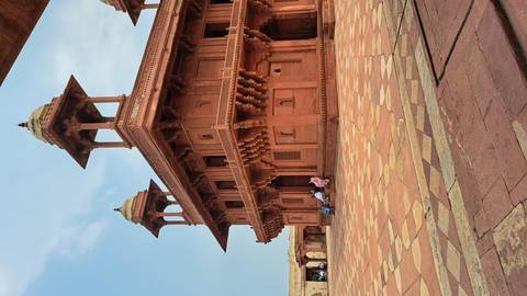 Visitors sitting outside a historic building.