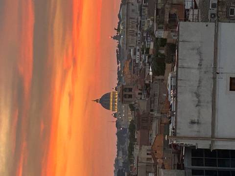 City skyline at sunset with a famous dome.