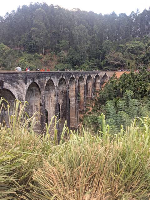 Famous Nine Arches Bridge in a lush environment.