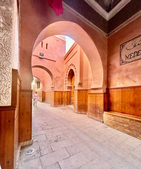       Traditional alleyway with a person walking.
  