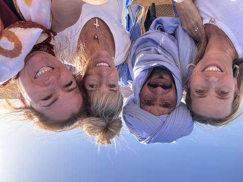 Group of friends taking a selfie in the desert.