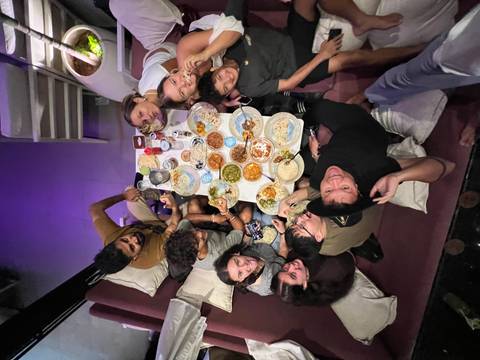       Group enjoying a traditional meal at a restaurant.
  