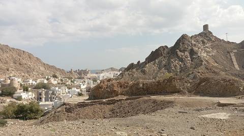 A mountainous landscape with a small village nestled at the base.