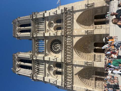 Notre Dame Cathedral with tourists gathered in front.