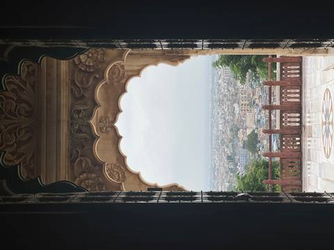       Cityscape view through an arched window.
  