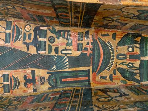       Colorful ancient Egyptian mural inside a tomb.
  