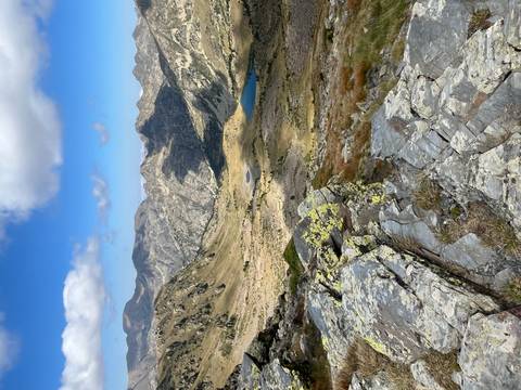       Rocky mountain terrain with a small lake visible from above.
  