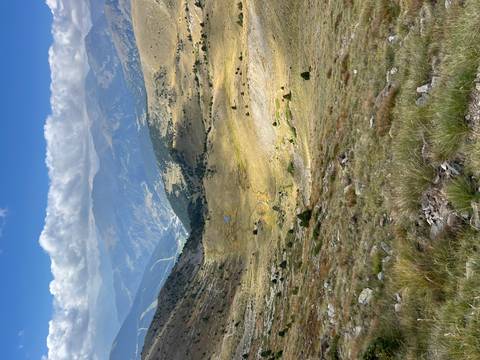      Expansive view of a mountainous landscape with a valley.
  