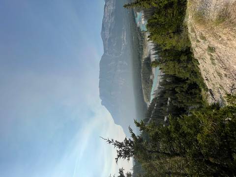 Riverside view with mountainous backdrop and clear sky.