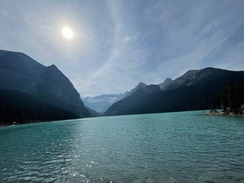 Panoramic view of Lake Louise with mountains and clear sky.