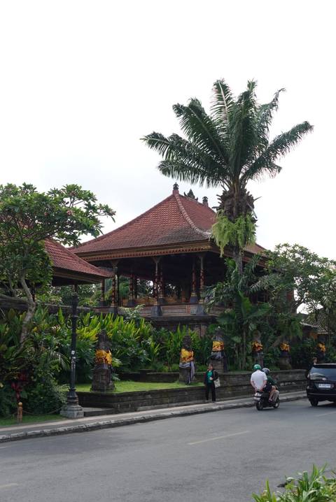       Traditional Balinese pavilion surrounded by tropical plants.
  