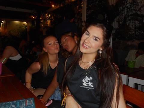 Three friends making faces at a restaurant or cafe.