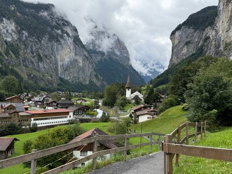       Scenic view of Lauterbrunnen valley with church and Alps.
  
