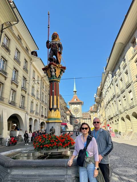       Zytglogge clock tower in Bern with people in foreground.
  