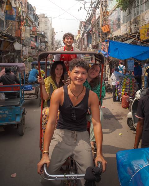       Group of people on a busy street in India.
  
