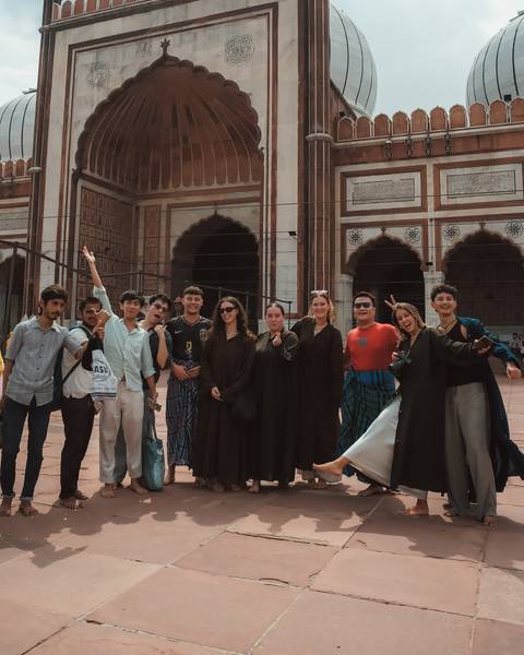       Group in front of a historical building in India.
  