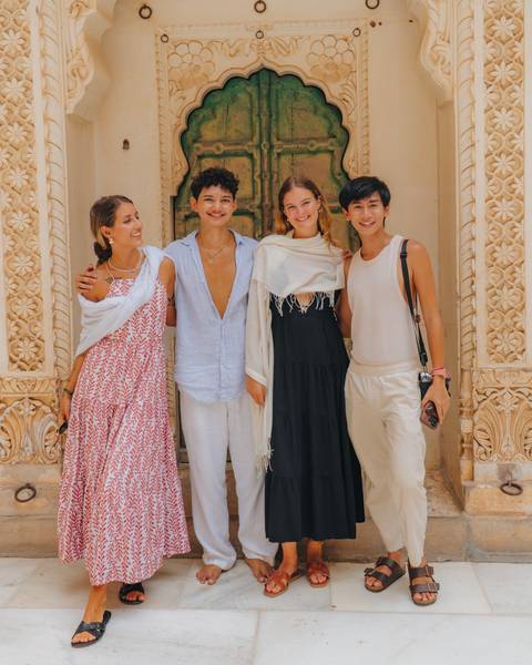       Friends posing at an ornate entrance.
  