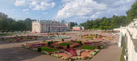 Beautiful garden with colorful flowers and a palace.