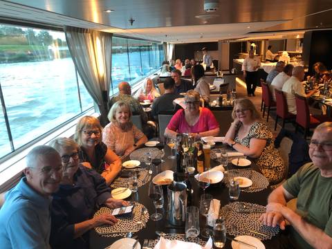 Group of people dining together on a cruise.